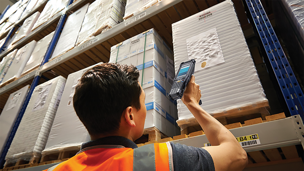 Image of a warehouse worker using a Zebra handheld scanner
